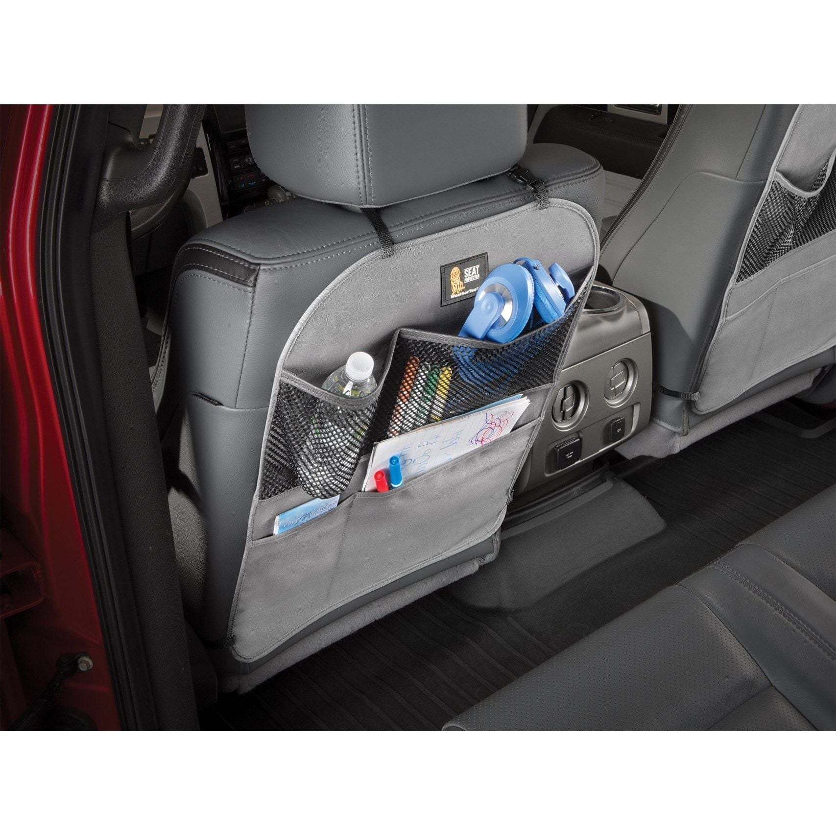 The WeatherTech Seat Back Protector in light grey, with storage for water bottles, headphones and childrens in car items.